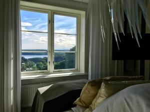 a bedroom with a window with a view of the water at Fredriksten Hotell in Halden
