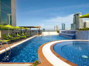 a swimming pool on the roof of a building at Fraser Suites Seef Bahrain in Manama