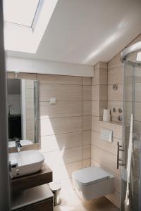 a bathroom with a toilet and a sink at The Nikolic Suites - Villa Wögenstein in Tribunj +232 photos