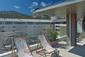 two chairs sitting on top of a balcony at Quintessens in Marseille