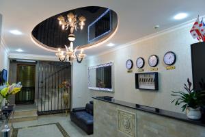 a lobby with a waiting area with clocks on the wall at Hotel Lion in Ureki