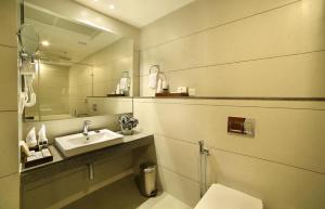 a bathroom with a sink and a mirror at Blanket Hotel & Spa in Munnar