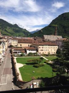 a city with a green park in front of buildings at Apartment G.Verdi in Bolzano