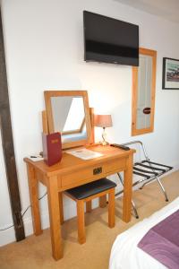 a bedroom with a desk with a mirror and a chair at Townend Farm Bed and Breakfast in Loftus