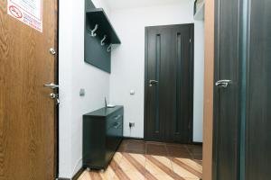 a hallway with two doors and a black cabinet at Apartments on Henerala Zhmachenka in Kyiv