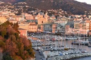 a group of boats docked in a harbor at Hôtel Des Gouverneurs in Bastia