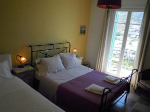 a bedroom with two beds next to a window at Blue Dolphin in Batsi
