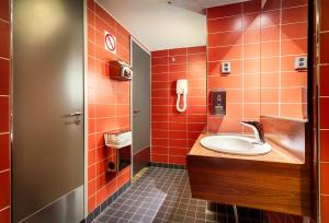 a bathroom with a sink and red tiles at Eurohostel in Helsinki +37 photos
