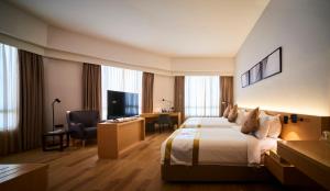 a hotel room with a bed and a desk at d'Sora Boutique Business Hotel in Kampong Baharu Jimah