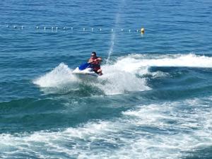 a man riding a jet ski in the water at Guest House Berto in Crikvenica