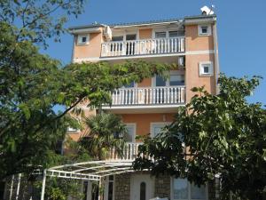 a tall building with a balcony on top of it at Guest House Berto in Crikvenica