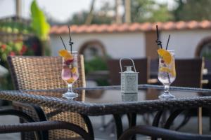 two glasses with fruit in them sitting on a table at Bed & Breakfast Delikates in Stojakovo