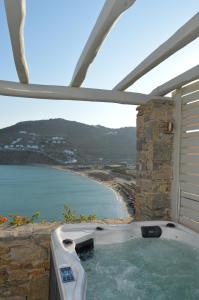 a bath tub with a view of the ocean at Sea Side Studios & Houses in Kalo Livadi