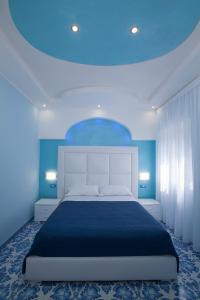 a bedroom with a large bed with a blue ceiling at Golfo Delle Sirene in Sorrento