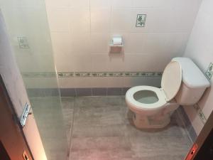 a small bathroom with a toilet and a shower at T.U.B. Mansion in Nonthaburi