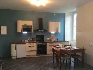 a kitchen with a table and a dining room at Chez Susan in Buzy