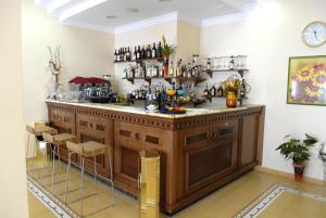 a bar in a room with a counter and stools at Hotel Paradiso Delle Madonie in Castelbuono