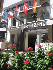 un hotel con bandiere di fronte a un edificio di Garni Hotel Zenit a Novi Sad