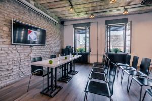 a room with a brick wall and a table and chairs at Veliki Garni Hotel in Novi Sad
