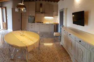 a kitchen with a table with a yellow table cloth on it at Montevenere 83 in Chiusi