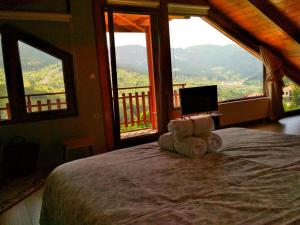 a bedroom with a bed with a laptop on it at Oresivio in Metsovo
