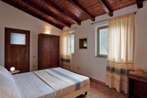 Llit o llits en una habitació de Agriturismo Casale Degli Ulivi Alghero