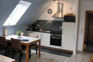 a kitchen with a table and a stove at Haus Karlo in Büsum