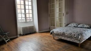 a bedroom with a bed and two large windows at Magnifique Maison de Caractère FAMILIALE 12 Couchages in Écouché