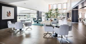 a lobby with a table and chairs and a couch at Ilunion Calas de Conil in Conil de la Frontera