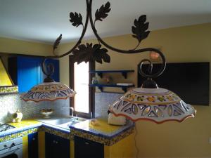 a kitchen with two lights hanging from the ceiling at La Maiolica B&B in Balestrate