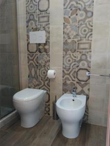 a bathroom with a toilet and a sink at La Maiolica B&B in Balestrate