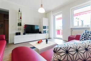 a living room with a couch and a tv at Ferienwohnung Burgblick in Bullay