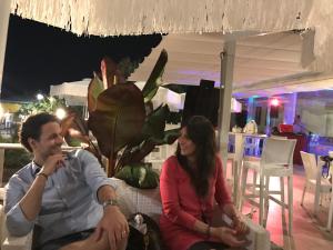 Un uomo e una donna seduti su un divano di Hotel Bellariva a Lido di Jesolo