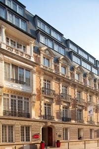 a large brick building with a lot of windows at Villathena in Paris