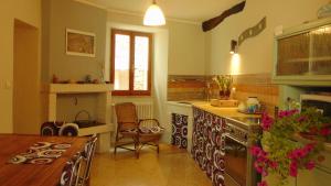 a kitchen with a table and a stove top oven at Le Cisterne B&B in Amelia