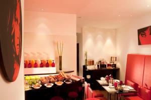 a restaurant with a buffet of food in a room at Villathena in Paris