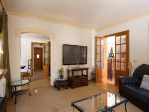 a living room with a couch and a flat screen tv at AGUAIT - Villa approximately aprox 4O OOO meters PLUS PRIVATE mountain approx 3 minutes walking from the beach Ideal for relaxation sport in Port de Pollensa