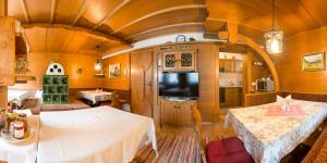 a train room with two tables and a tv at Ferienhaus Pension Gulla in Neustift im Stubaital