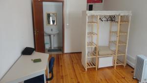 a small room with a wooden floor and shelves at BE Coimbra Hostels in Coimbra