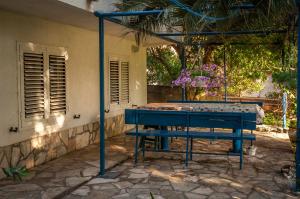 a blue ping pong table in front of a house at Apartments Villa Petranović in Budva
