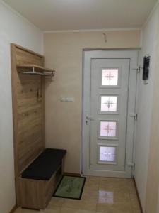 a room with a door and a bench next to it at Apartments Milena in Pinezici