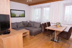 a living room with a couch and a table at Landhaus Huber in Altenmarkt im Pongau