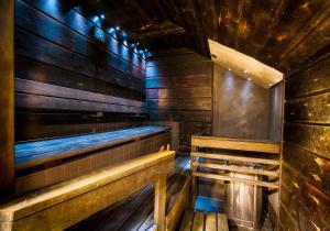 an empty sauna with wooden walls and wooden benches at Eurohostel in Helsinki