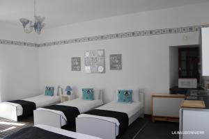 a room with four beds with blue pillows at Chambre d'hôte Manoir de La Baudonnière in Monsireigne +100 photos