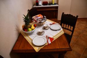 a table with plates and a bowl of fruit on it at GB Apartments - Belle Epoque in Arad