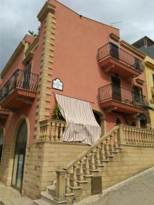 a building with stairs and balconies on it at La Maiolica B&B in Balestrate