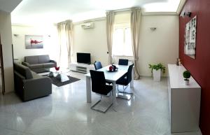 a living room with a table and a couch at My Place in Siracusa