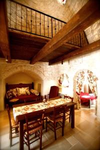 a dining room with a table and a couch at Trulli e Puglia Resort in Alberobello