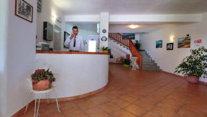 a man standing at a counter in a room at Hotel Villa Rita in Ischia +37 photos