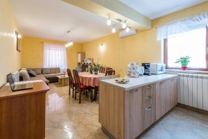 kuchnia ze stołem i salon w obiekcie Apartment Sandi w mieście Tinjan
